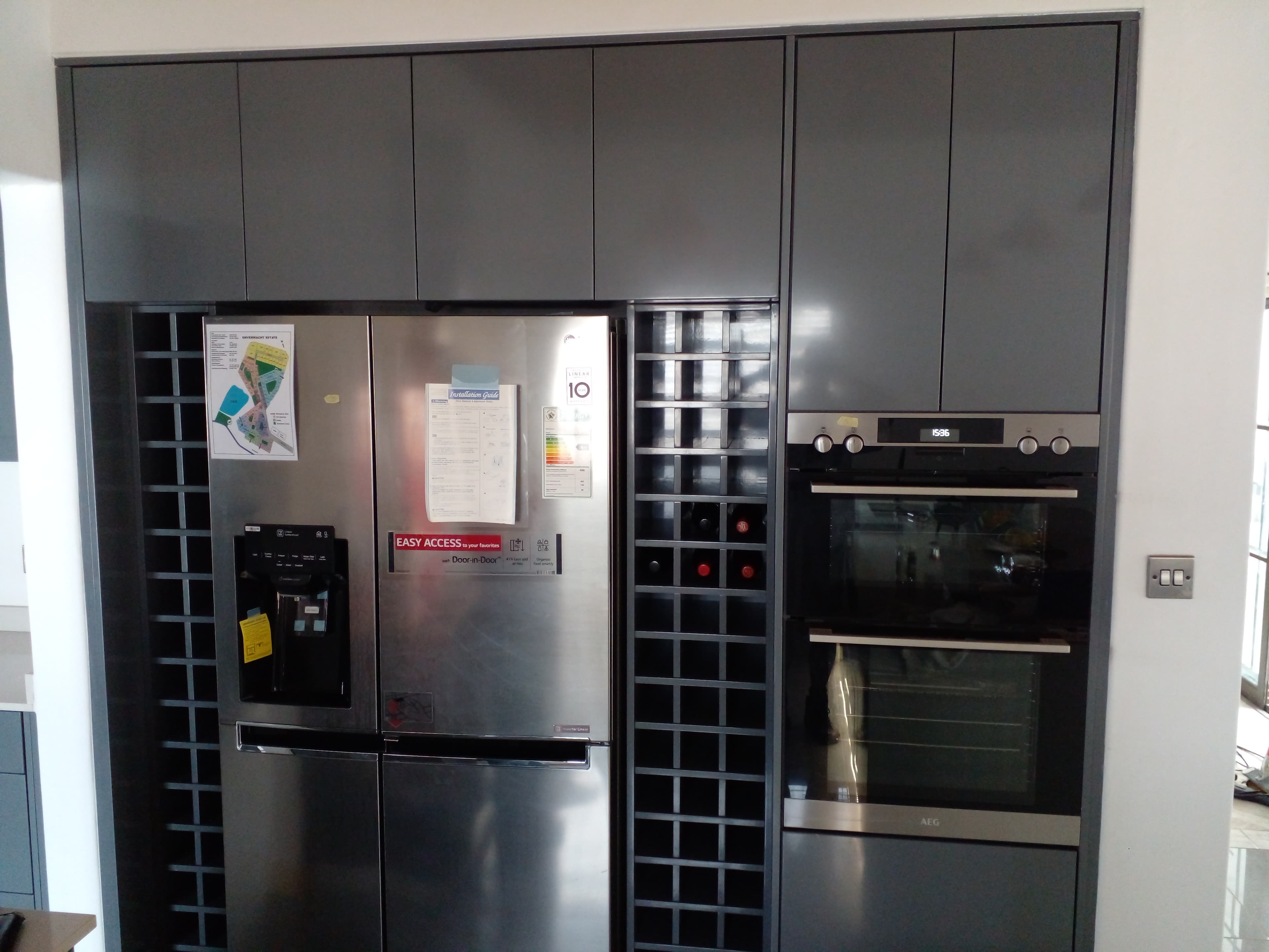 Dark grey Duco kitchen with wine grid and integrated appliances