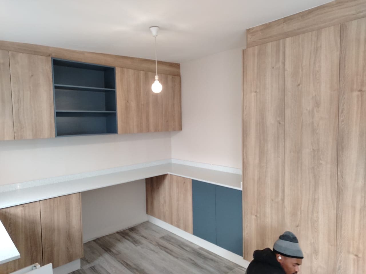 Built-in home study with oak melamine and teal accent cabinets